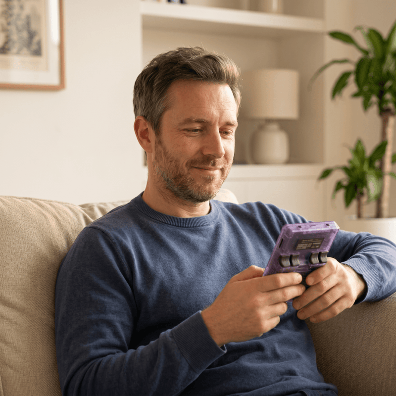 Person playing the NorAlert Pro 2.0 R36S retro gaming console at home