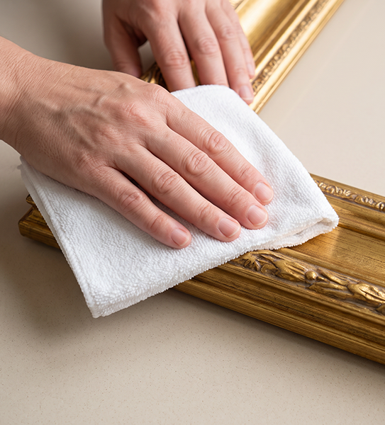 Wiping a gold finish with a soft cloth